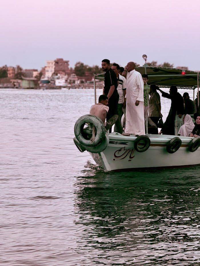 People enjoy a serene boat ride along the river in Rosetta, Egypt at sunset.
